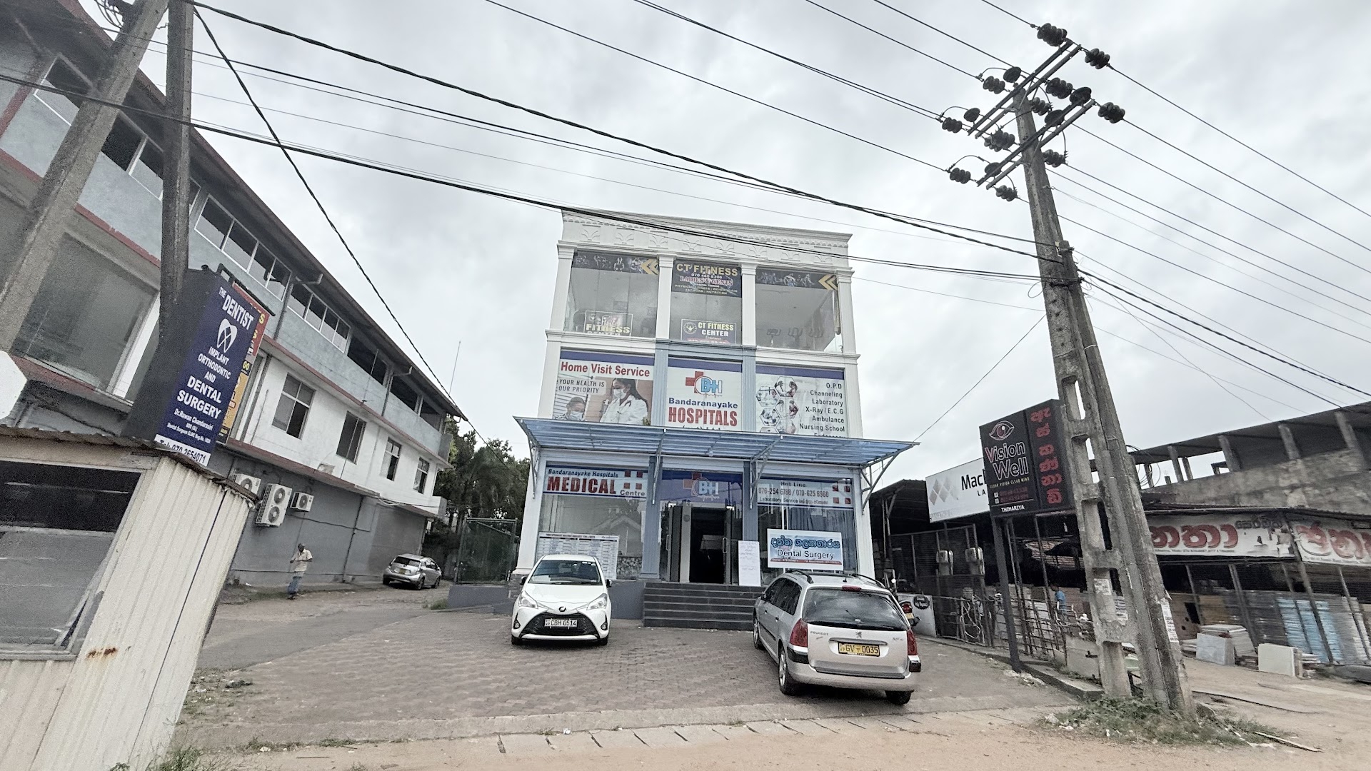 Street view of U Care Medical Center in Kalagedihena with THE DENTIST sign visible on the left