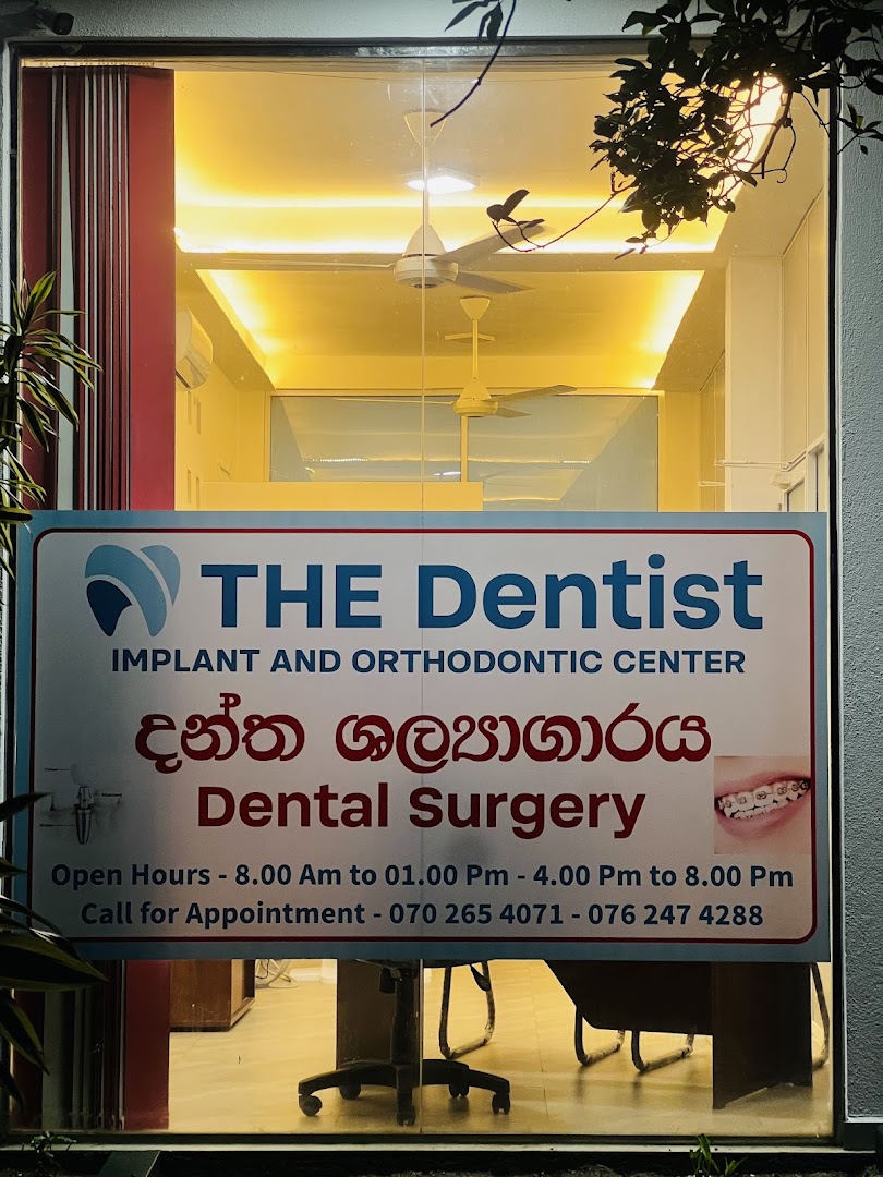 THE DENTIST exterior sign identifying implant, orthodontic, and dental surgery services